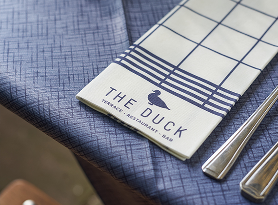 Close-up of custom napkin on navy blue Dunisilk® table cover