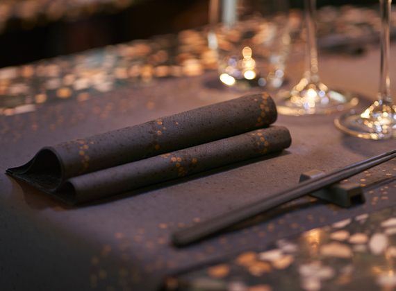 Folded linen feel New Year themed napkin on matching table runner